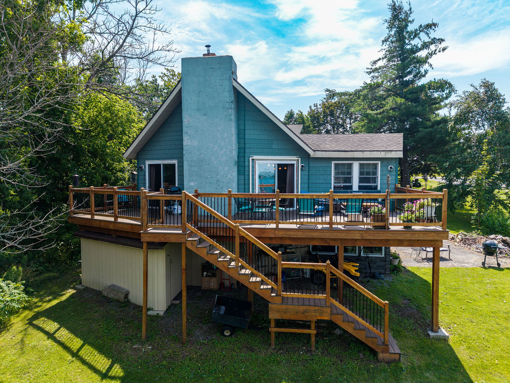 Waterfront home at 6199 State Highway 37 with a large deck overlooking the St. Lawrence River